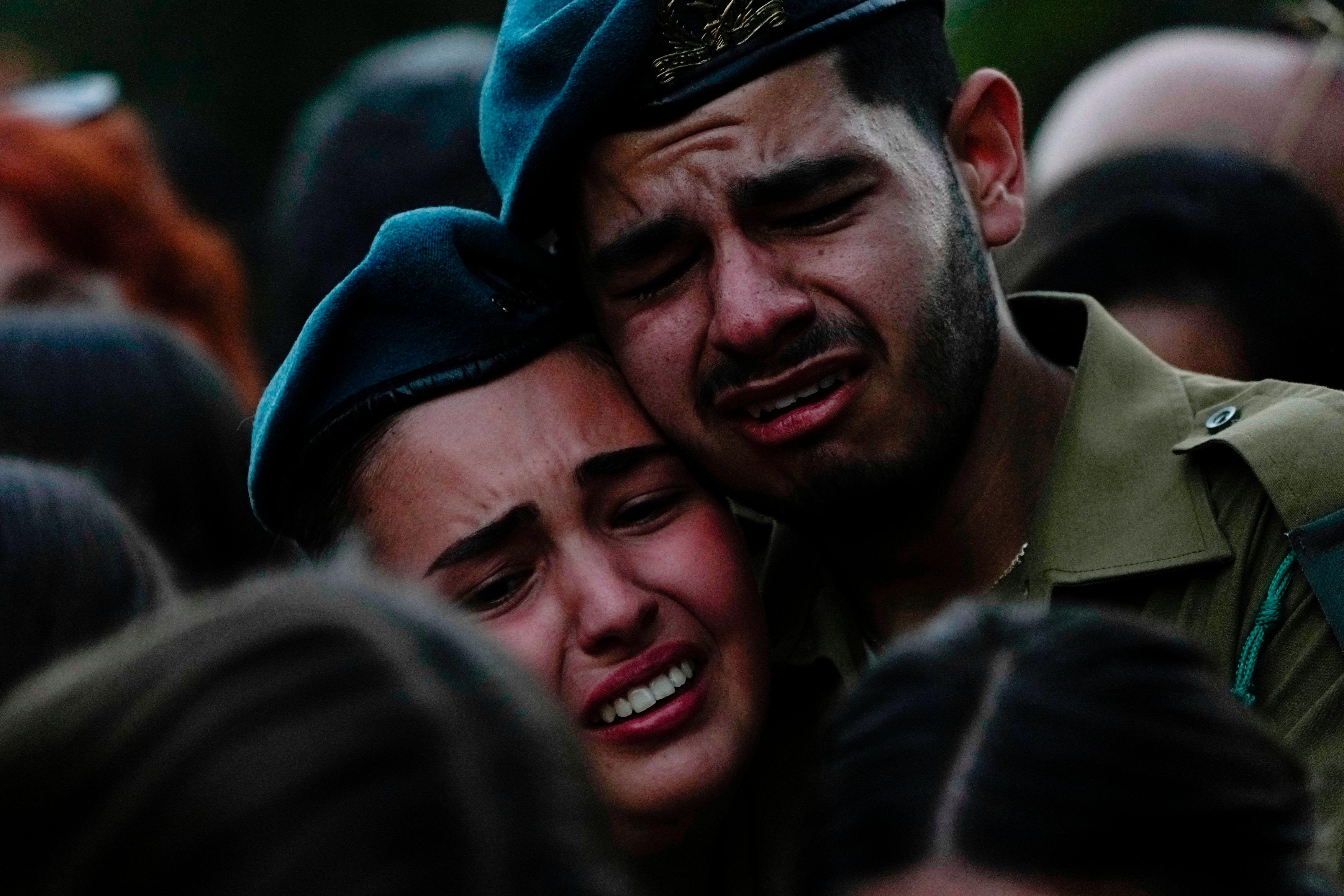 Israeli soldiers cry during the funeral of Sgt. Yam Goldstein and her father, Nadav, in Kibbutz Shefayim, Israel, on October 23.