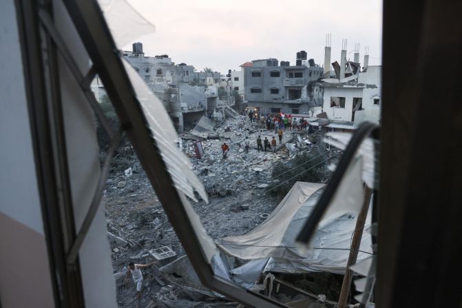 Palestinians look for survivors in the rubble after Israeli strikes in Rafah in southern Gaza on October 23.