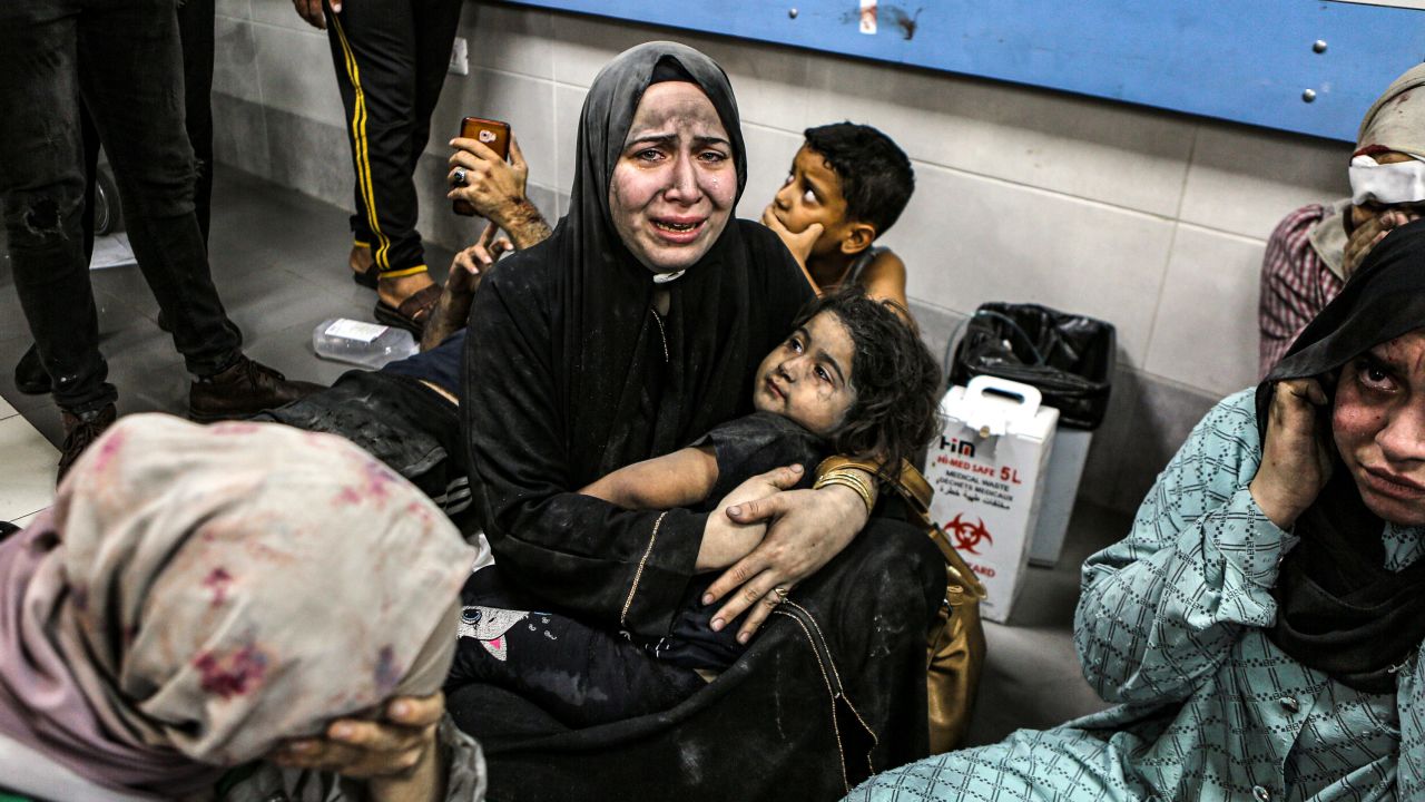 Wounded Palestinians sit in al-Shifa hospital in Gaza City, central Gaza Strip, after arriving from al-Ahli hospital following an explosion there, Tuesday, Oct. 17, 2023. The Hamas-run Health Ministry says an Israeli airstrike caused the explosion that killed hundreds at al-Ahli, but the Israeli military says it was a misfired Palestinian rocket. (AP Photo/Abed Khaled)