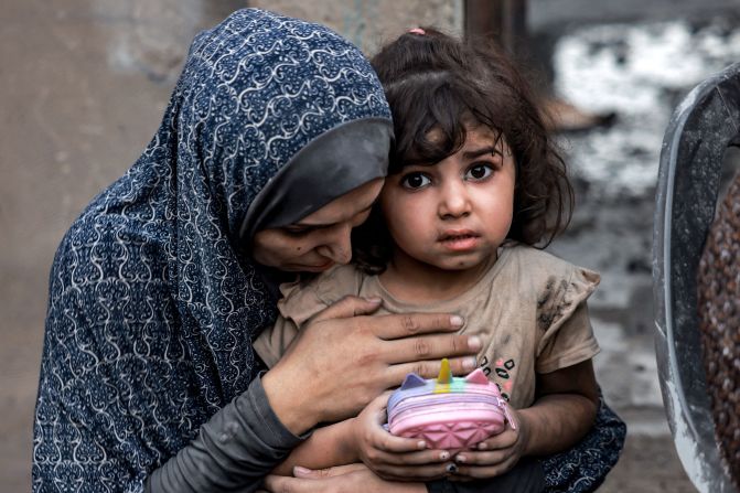 A Palestinian family sits near destroyed houses following a strike in Rafah, southern Gaza, on November 6.