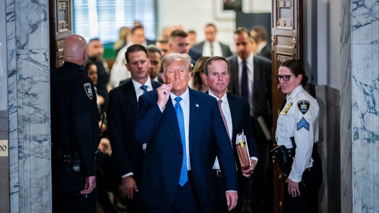 New York, NY - November 6 : Former President Donald Trump gestures a zipped lip as he walks out of the courtroom during a break before testifying in his civil fraud case at the State Supreme Court of New York on Monday, Nov. 06, 2023, in New York, NY. (Photo by Jabin Botsford/The Washington Post via Getty Images)