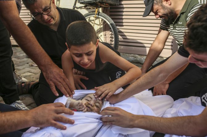 Khaled Joudeh mourns his young sister, Misq, at the morgue at Deir Al-Balah hospital in Gaza on October 22. 