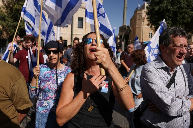 People hold Israeli flags in Jerusalem on November 7, one month after Hamas's attacks in Israel.