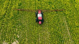 A farmer spreads pesticide on a field in Centreville, Maryland, on April 25, 2022. (Photo by Jim WATSON / AFP) (Photo by JIM WATSON/AFP via Getty Images)