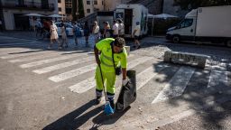 A municipal worker cleans the streets in front of the Cathedral of Santa Maria during high temperatures in the old town area of Girona, Spain, on Wednesday, Aug. 23, 2023. Heatwaves may "reduce Southern Europe's attractiveness as a tourist destination in the longer term or at the very least reduce demand in summer," according to Moody's Investors Service. Photographer: Angel Garcia/Bloomberg via Getty Images