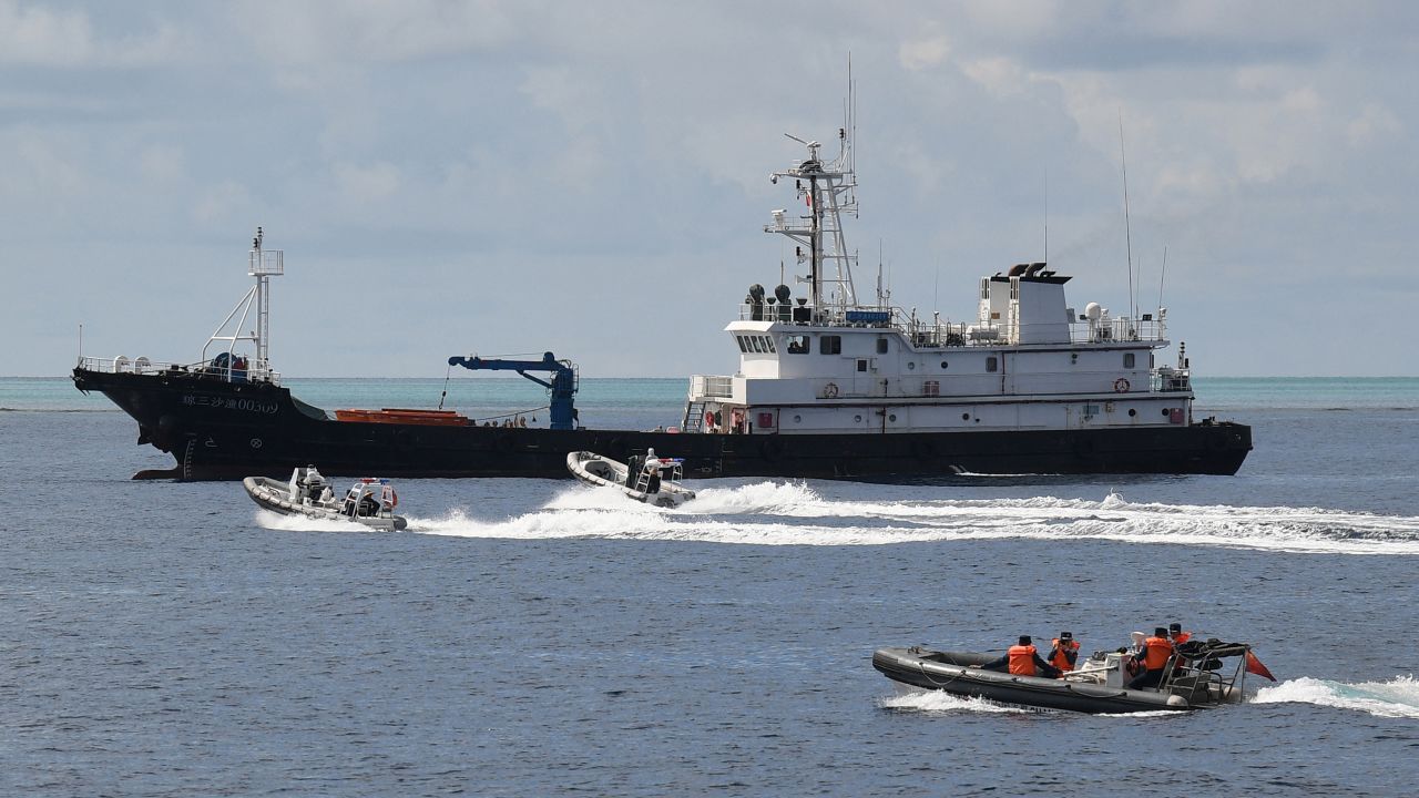 This photo taken on September 22, 2023 shows Chinese coast guard personnel aboard rigid hull inflatable boats sailing near a Chinese maritime militia vessel in Chinese-controlled Scarborough Shoal in waters of the disputed South China Sea. China, which claims sovereignty over almost the entire South China Sea, snatched control of Scarborough Shoal from the Philippines in 2012. Since then, it has deployed coast guard and other vessels to block or restrict access to the fishing ground that has been tapped by generations of Filipinos. (Photo by Ted ALJIBE / AFP) (Photo by TED ALJIBE/AFP via Getty Images)