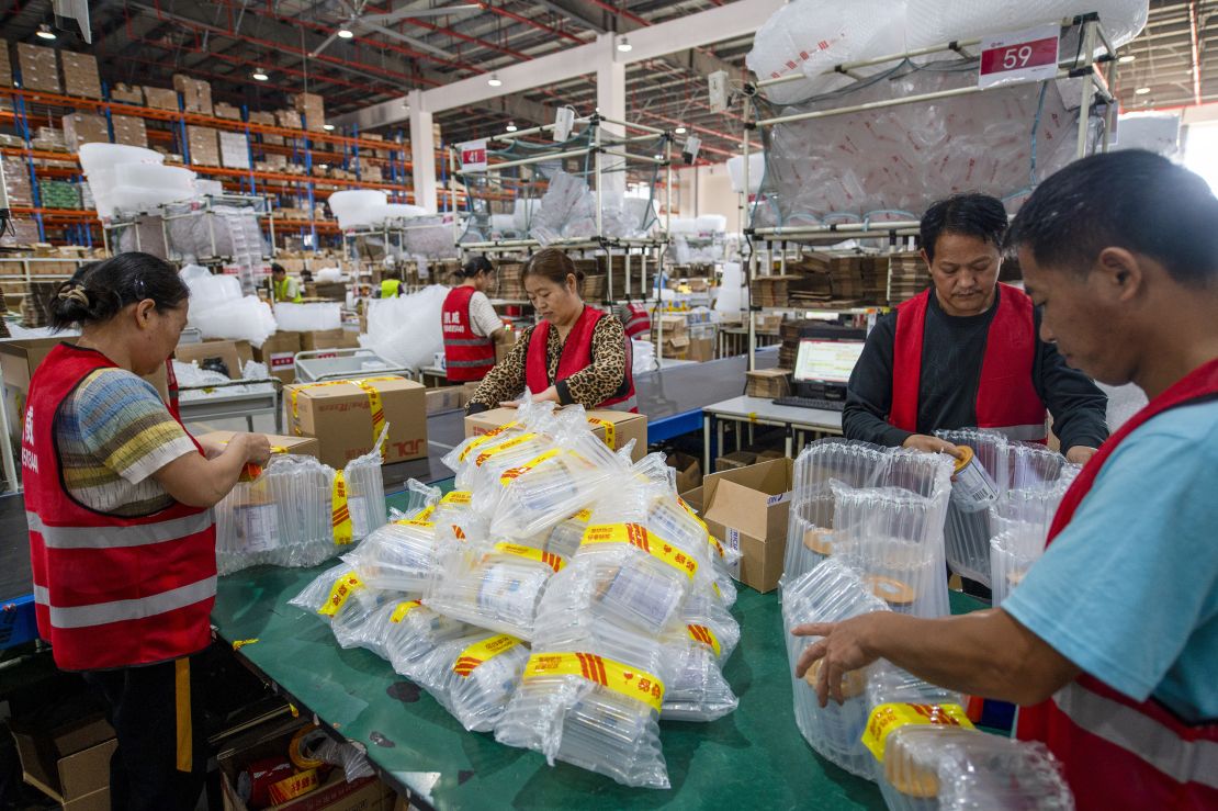 JINHUA, CHINA - NOVEMBER 01: Employees pack items into boxes at a warehouse of an e-commerce company ahead of China's Double 11 Shopping Festival on November 1, 2023 in Jinhua, Zhejiang Province of China. (Photo by Hu Xiaofei/VCG via Getty Images)