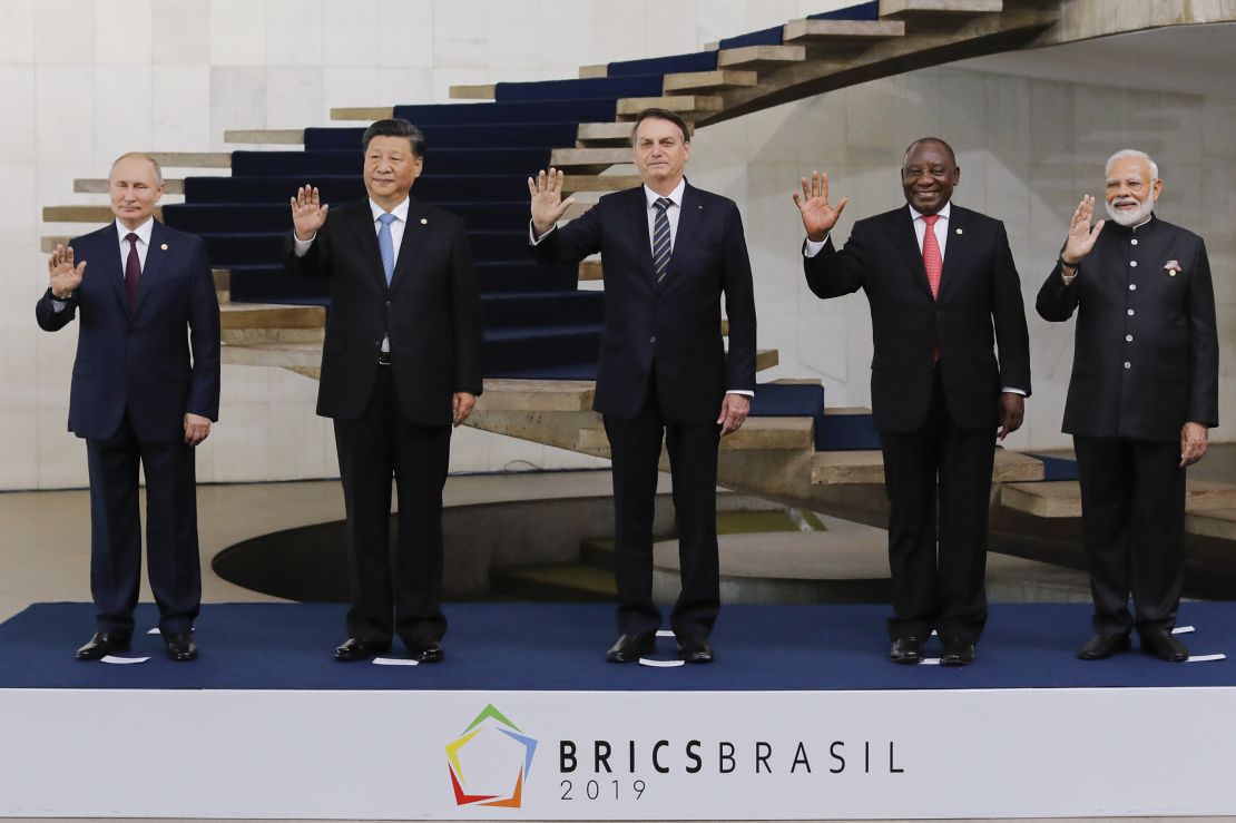 Russia's President Vladimir Putin (L), China's President Xi Jinping (2nd L), Brazil's President Jair Bolsonaro (C), South Africa's President Cyril Ramaphosa (2nd R),India's Prime Minister Narendra Modi (R) pose for a family picture during the 11th BRICS Summit on November 14, 2019 in Brasilia, Brazil. - Brazil's President Jair Bolsonaro walked a diplomatic tightrope, as he seeks to boost ties with Beijing and avoid upsetting key ally Donald Trump, on the eve of a summit with their BRICS counterparts from Russia, India and South Africa. (Photo by Sergio LIMA / AFP) (Photo by SERGIO LIMA/AFP via Getty Images)