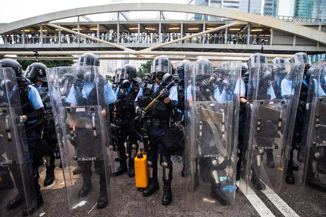 Riot police stand guard near the Legislative Council during a protest against a proposed extradition law in Hong Kong, China, on Wednesday, June 12, 2019. Protesters blocking major roads in downtown Hong Kong vowed to stay until the government withdraws controversial legislation that would for the first time allow extraditions to China. Photographer: Sanjit Das/Bloomberg via Getty Images