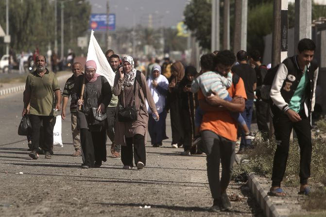 A woman carries a white flag as Palestinians flee from Gaza City to the south on November 7.