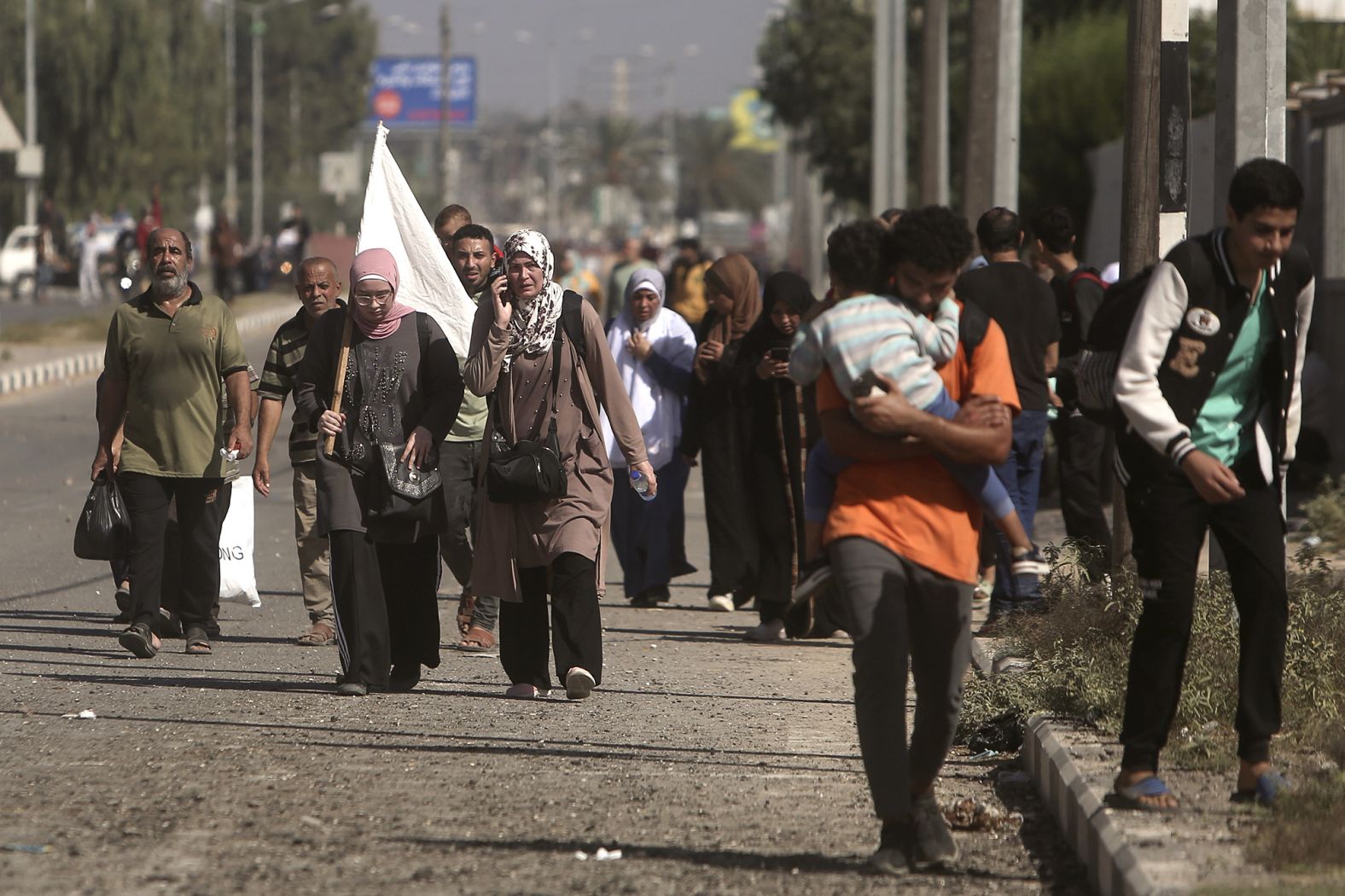 A woman carries a white flag as Palestinians flee from Gaza City to the south on November 7.