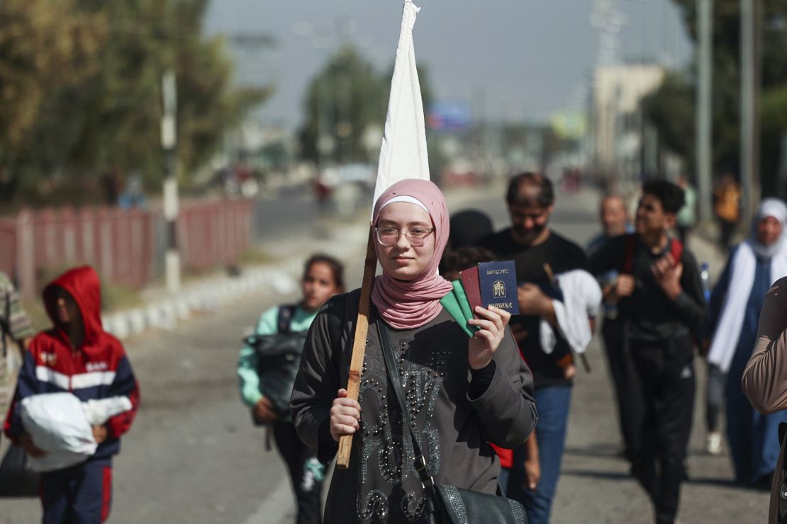 A Palestinian woman carries her passport and ID as she flees Gaza City towards the southern areas walking on a road on November 7, 2023, amid the ongoing battles between Israel and the Palestinian Islamist group Hamas. Thousands of civilians, both Palestinians and Israelis, have died since October 7, 2023, after Palestinian Hamas militants based in the Gaza Strip entered southern Israel in an unprecedented attack triggering a war declared by Israel on Hamas with retaliatory bombings on Gaza. (Photo by /Sipa USA)(Sipa via AP Images)