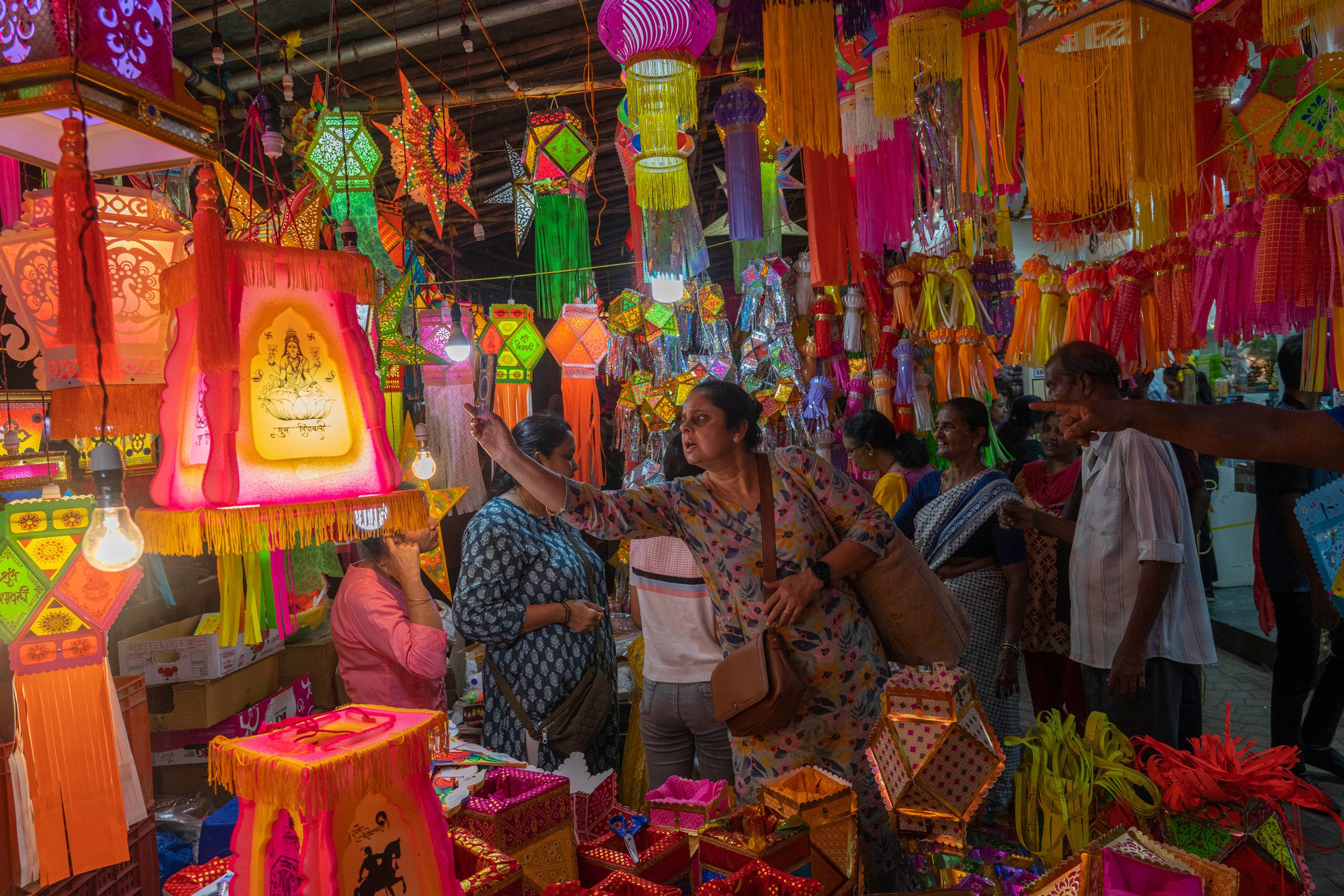 People look at lanterns displayed for sale at roadside stalls ahead of Diwali festival in Mumbai, India, Sunday, Nov. 5, 2023. (AP Photo/Rafiq Maqbool)