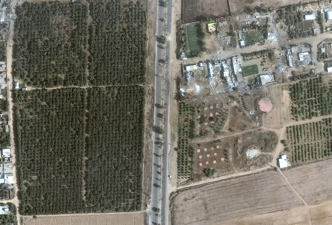 Groups of people walk along Salah a-Din road as they evacuate south from Gaza City.