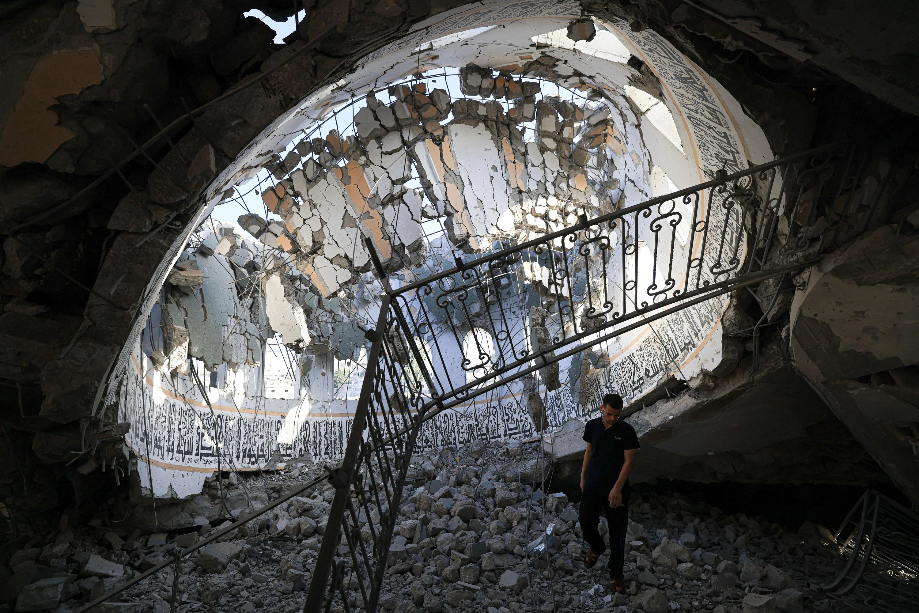 Palestinians inspect debris at the Khaled Ibn Al-Walid mosque after it was hit by an Israeli bombardment in Khan Younis, on November 8.