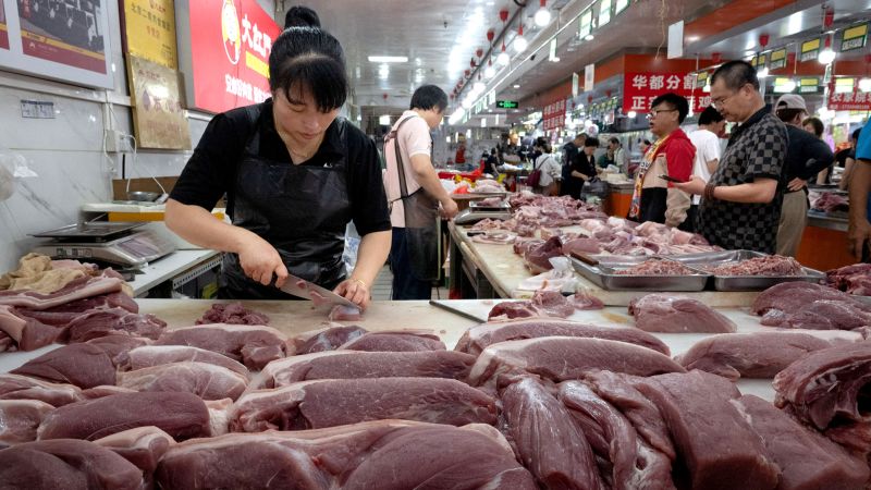 Plunging pork prices tip China back into deflation | CNN Business