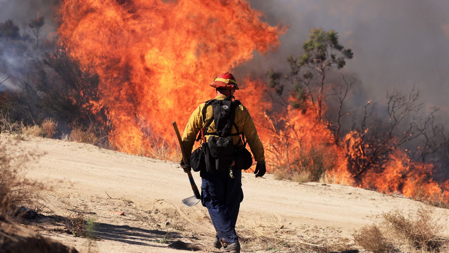 TOPSHOT - A firefighter walks toward flames as the Highland Fire burns in Aguana, California, on October 31, 2023. Thousands of people were being told to flee a wildfire spreading in southern California on October 31, as strong winds fanned the flames.
Around 5,700 people were urged to leave areas threatened by the blaze, which erupted on October 30 around lunchtime and had engulfed 2,200 acres (900 hectares) by the following morning. (Photo by DAVID SWANSON / AFP) (Photo by DAVID SWANSON/AFP via Getty Images)