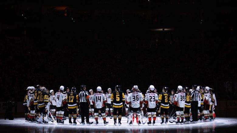 PITTSBURGH, PENNSYLVANIA - OCTOBER 30: Pittsburgh Penguins and Anaheim Ducks players stand for a moment of silence following the death of former Penguins player Adam Johnson, prior to their game at PPG PAINTS Arena on October 30, 2023 in Pittsburgh, Pennsylvania. (Photo by Harrison Barden/Getty Images)