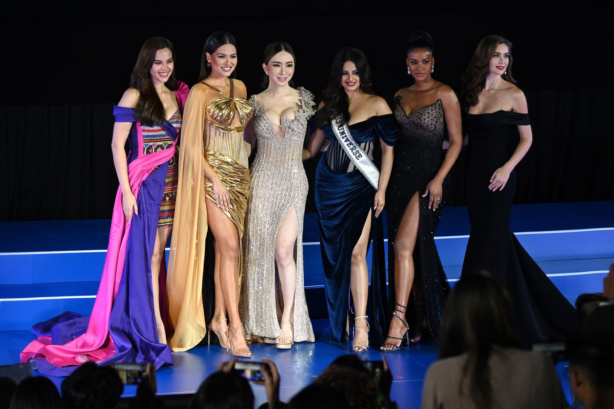 (L-R) Miss Universe 2018 Catriona Gray, Miss Universe 2020 Andrea Meza, CEO of JKN Global Group Jakapong Anne Jakrajutatip, Miss Universe 2021 Harnaaz Sandhu, Miss Universe 2011 Leila Lopes and Miss Universe 2005 Natalie Glebova stand on stage together during the Miss Universe Extravaganza, after JKNs acquisition of the Miss Universe franchise, in Bangkok on November 7, 2022. (Photo by Lillian SUWANRUMPHA / AFP) (Photo by LILLIAN SUWANRUMPHA/AFP via Getty Images)