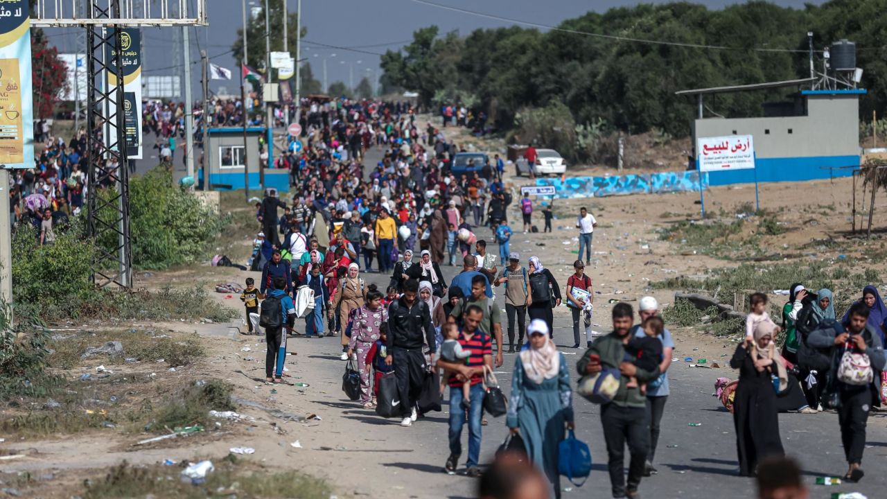 Palestinian families fleeing northern Gaza walk south along a highway on November 9.