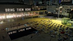People look at an installation called "Empty Beds" on November 9 in Tel Aviv, where beds represent around 240 hostages seized in the attack by Hamas gunmen.