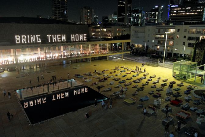 People look at an installation called "Empty Beds" on November 9 in Tel Aviv, where beds represent around 240 hostages seized in the attack by Hamas gunmen.