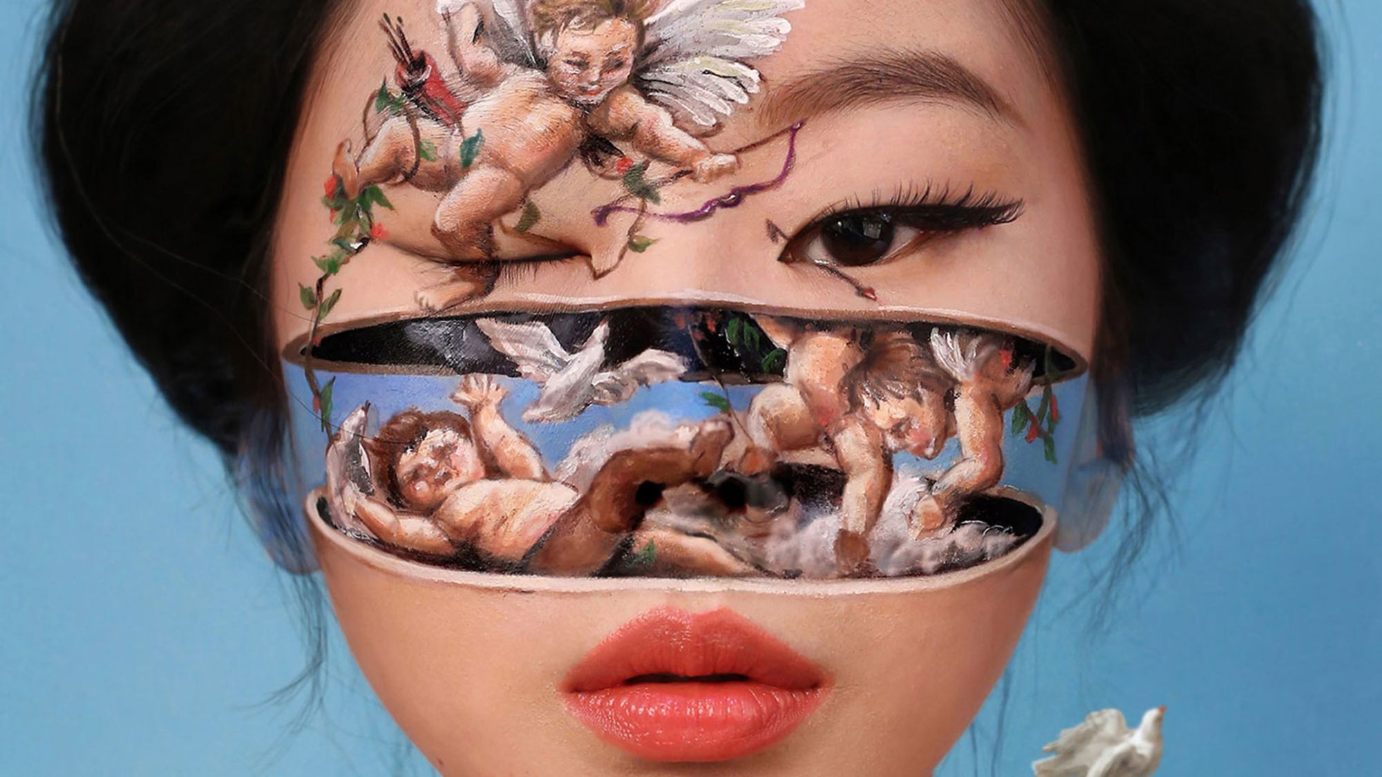 The artist uses her face to paint captivating and intricate scenes that often trick the eye with 3D shading.