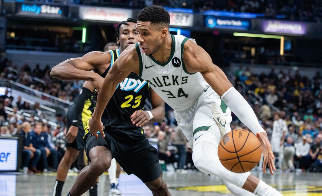 Nov 9, 2023; Indianapolis, Indiana, USA; Milwaukee Bucks forward Giannis Antetokounmpo (34) dribbles the ball while Indiana Pacers forward Aaron Nesmith (23) defends in the first half at Gainbridge Fieldhouse. Mandatory Credit: Trevor Ruszkowski-USA TODAY Sports