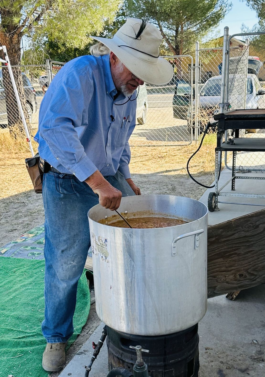 Sam Schultz prepares food for migrants in a makeshift kitchen. Migrants wait in camp sites along the U.S./Mexico border to be processed by U.S. Border Protection authorities to request asylum.