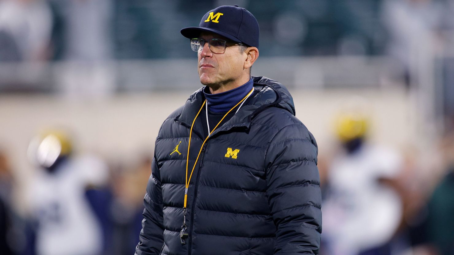 Michigan coach Jim Harbaugh watches during warmups before an NCAA college football game against Michigan State, Saturday, Oct. 21, 2023, in East Lansing, Mich. (AP Photo/Al Goldis)