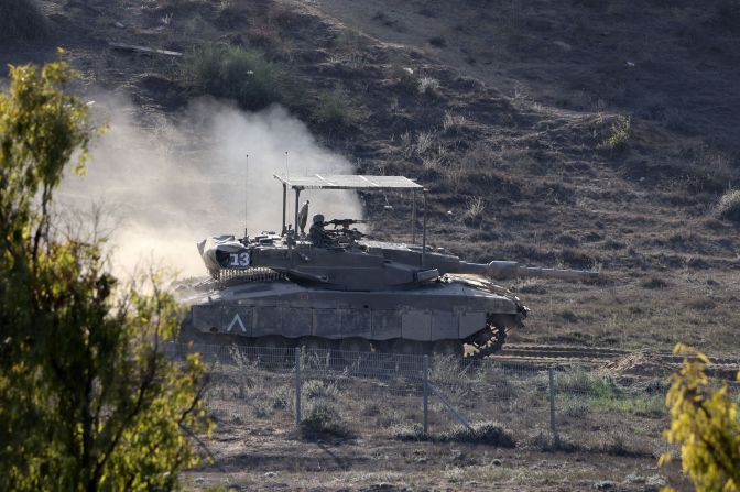 An Israeli tank rolls near Sderot, Israel, along the border with Gaza, on November 10.