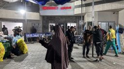 People stand outside the emergency ward of Al-Shifa hospital in Gaza City on Friday. 