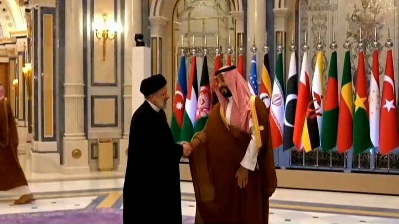 Iranian President Ebrahim Raisi, left, shakes hands with Saudi Crown Prince Mohammed bin Salman on November 11.