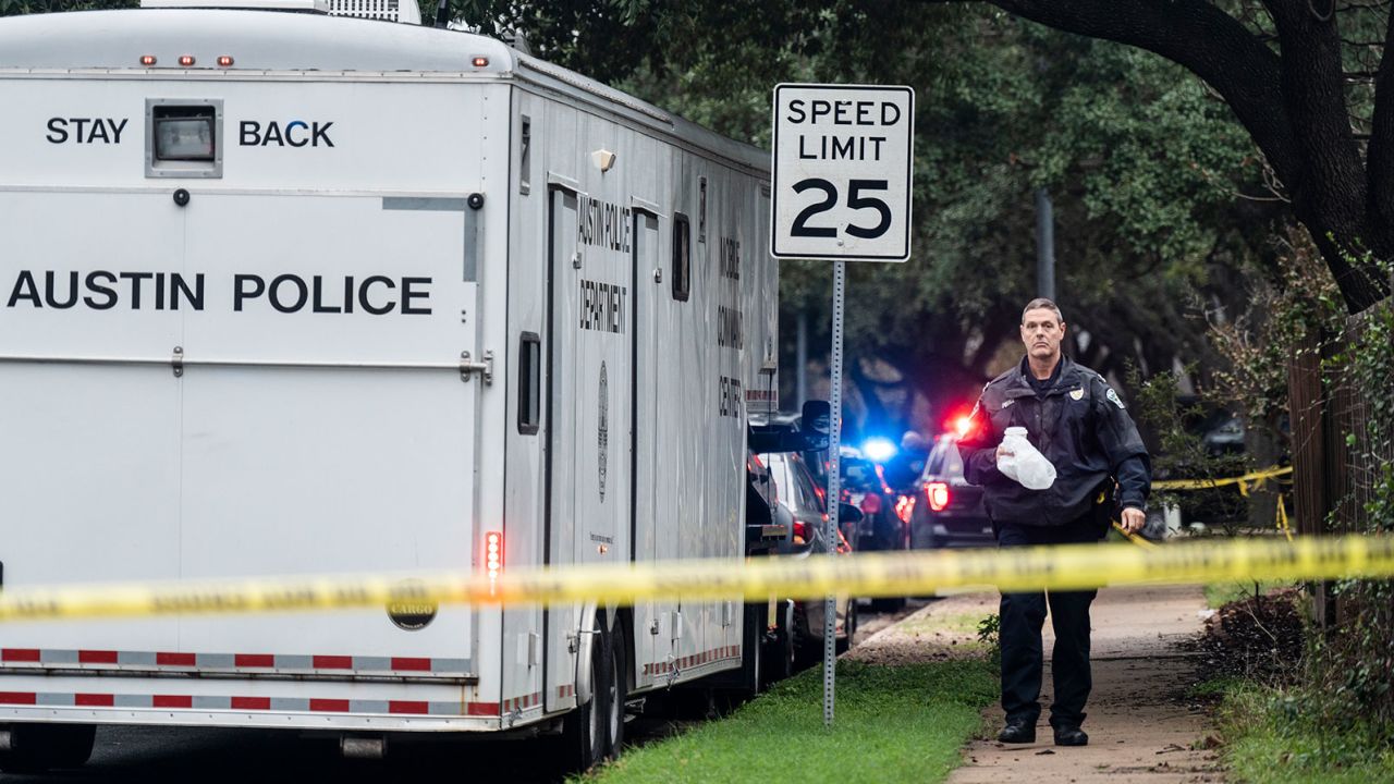 The Austin Police Department investigates the crime scene after an Austin police officer died following a shooting in South Austin, Texas on Saturday, Nov. 11, 2023. A second officer was wounded in the shooting early Saturday that also left the suspected gunman dead, according to a post on the City Council message board by the mayor's chief of staff. (Mikala Compton/Austin American-Statesman via AP)