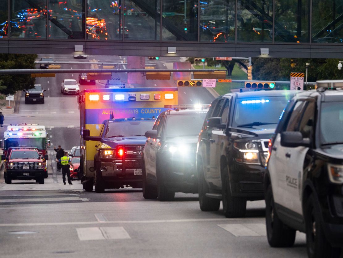 A procession including Austin Fire, Police and EMS leaves Dell Seton Medical Center in Downtown Austin following the shooting death of a police officer early Saturday, Nov. 11, 2023. A second officer was wounded in the shooting early Saturday that also left the suspected gunman dead, according to a post on the City Council message board by the mayor's chief of staff. (Sara Diggins/Austin American-Statesman via AP)