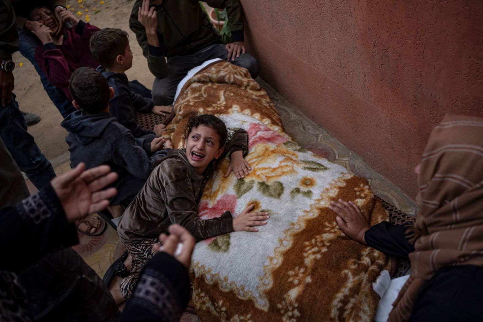 Palestinians mourn relatives killed in Israeli bombardment at a hospital in Khan Younis, Gaza, on November 11.