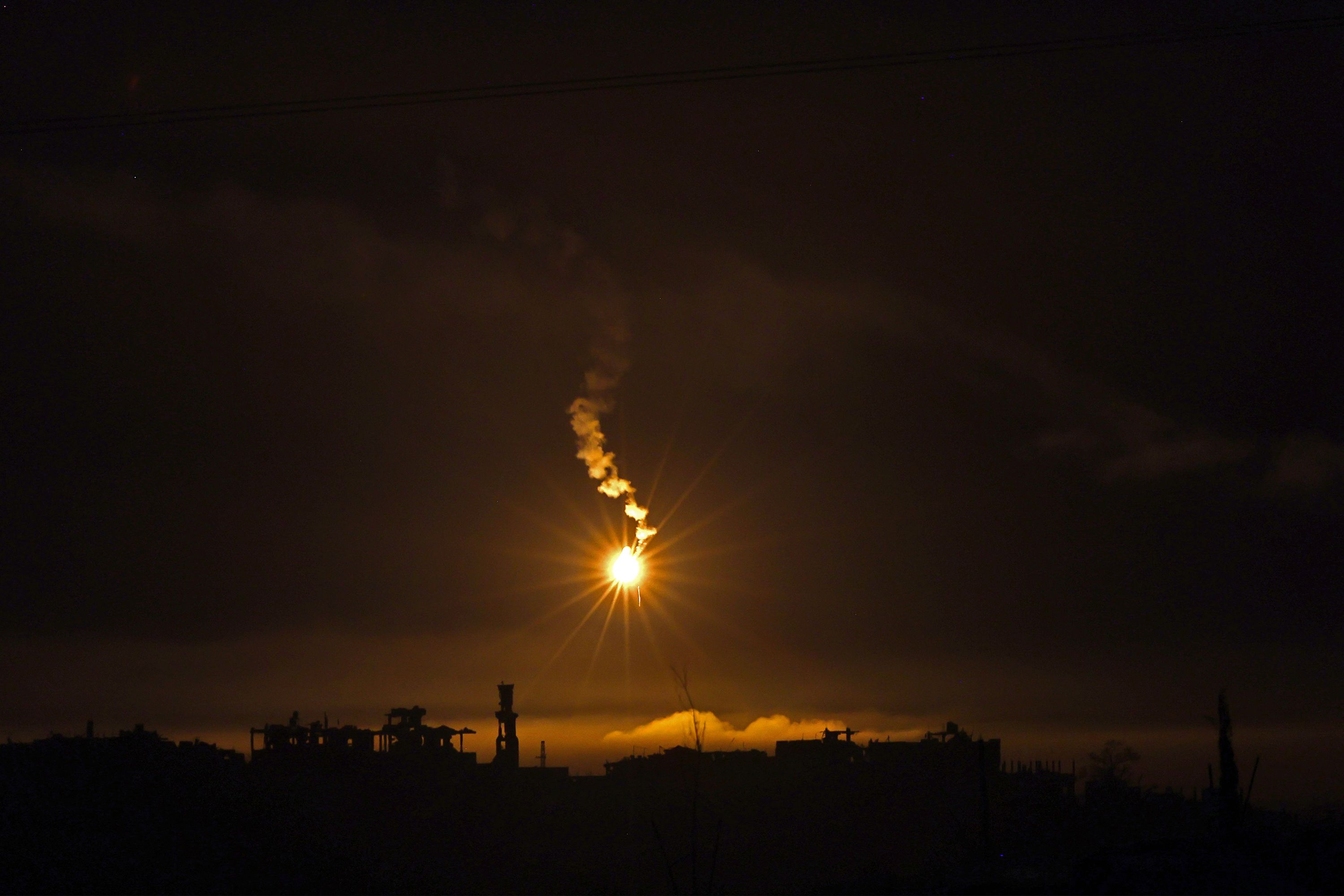 This picture taken from the Israeli side of the border with the Gaza Strip early on Sunday, November 12, shows flares being fired by Israeli troops over the Gaza Strip.