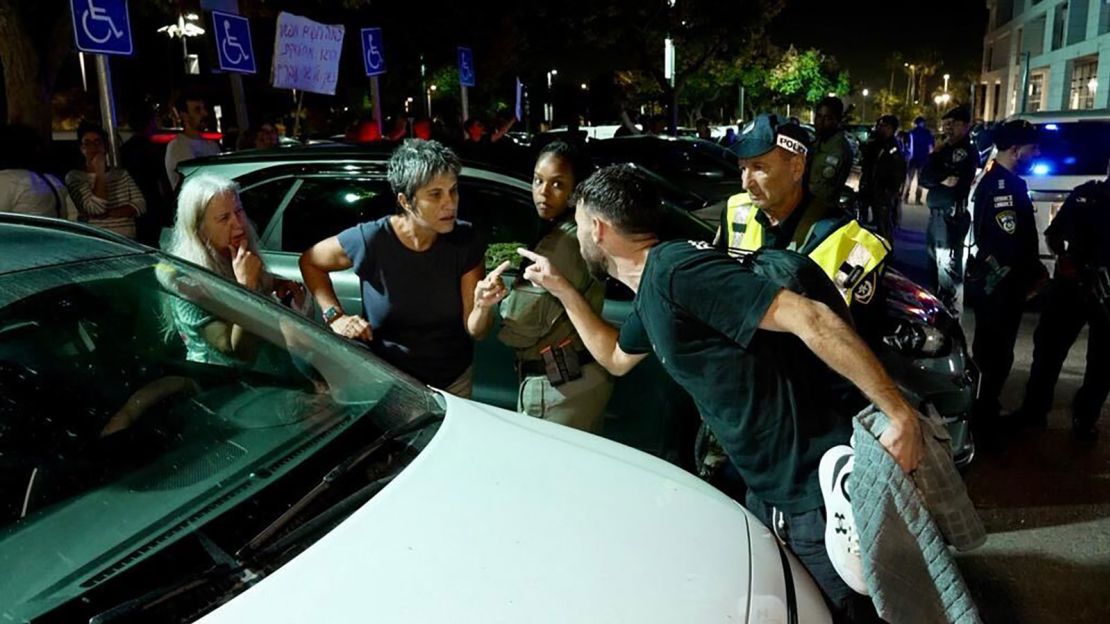 Protesters and an anti-protester argue outside an event attended by Ben-Gvir in Caesarea, Israel, in November 2023.