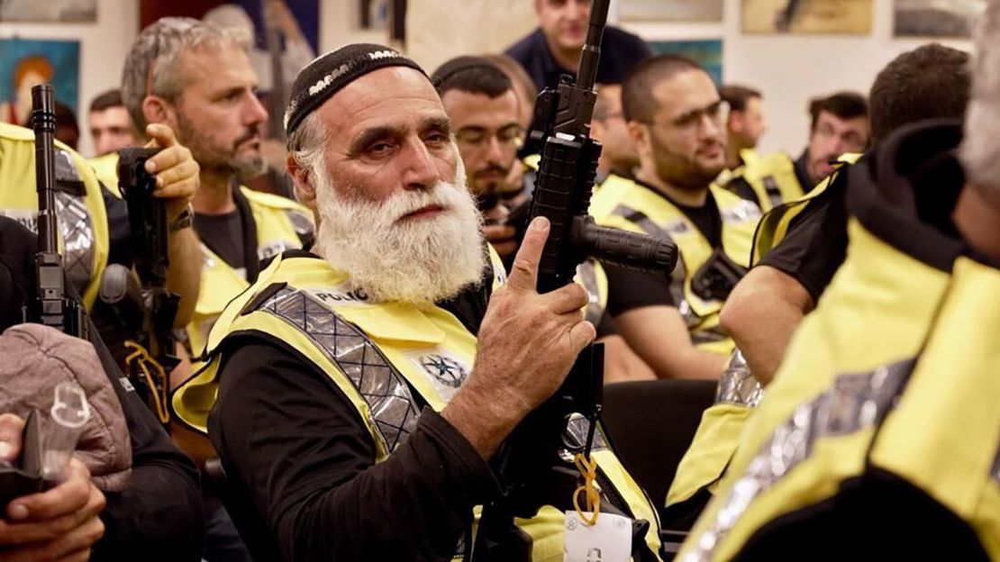 A civilian security squad member holds a rifle at an event attended by Israeli National Security Minister Itamar Ben-Gvir.