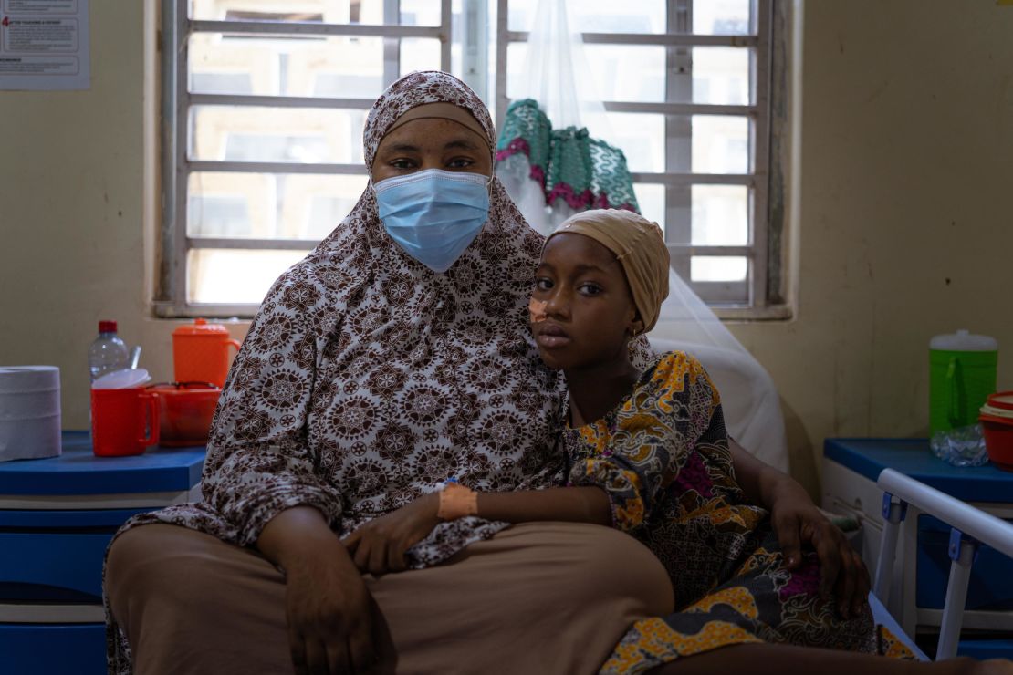 A mother caring for her daughter who has recently recovered from diphtheria