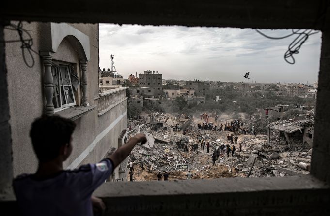 Palestinians search for bodies and survivors among the rubble of a residential building following an Israeli strike in Khan Younis, Gaza, on November 12.