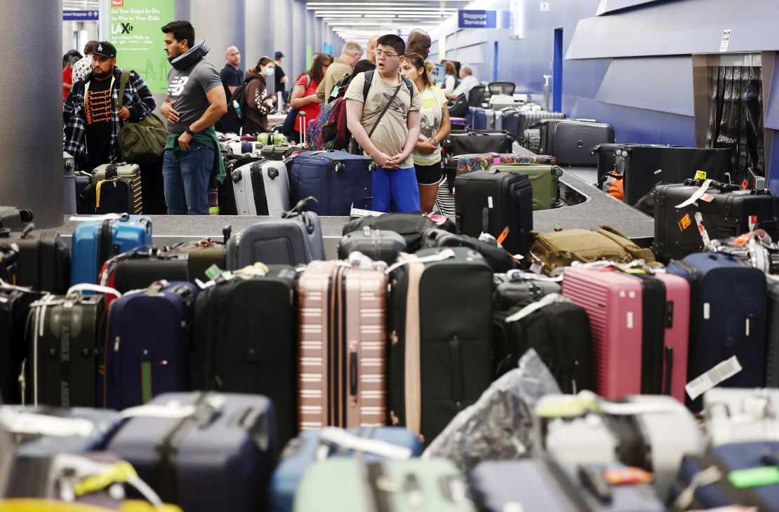 LOS ANGELES, CALIFORNIA - JUNE 29: Travelers wait for their bags amid rows of unclaimed luggage at the United Airlines baggage claim area at Los Angeles International Airport (LAX) on June 29, 2023 in Los Angeles, California. United Airlines cancelled hundreds of flights again today amid a chaotic week of flight cancellations and delays amid weather issues and strong traveler demand. United Airlines has cancelled nearly 3,000 flights since June 24th as the July 4th holiday travel rush nears. (Photo by Mario Tama/Getty Images)