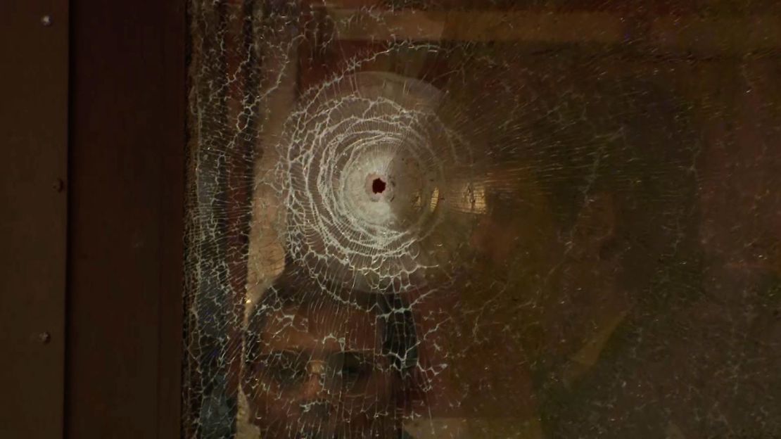 A bullet hole can be seen in the glass of one of the school's doors.