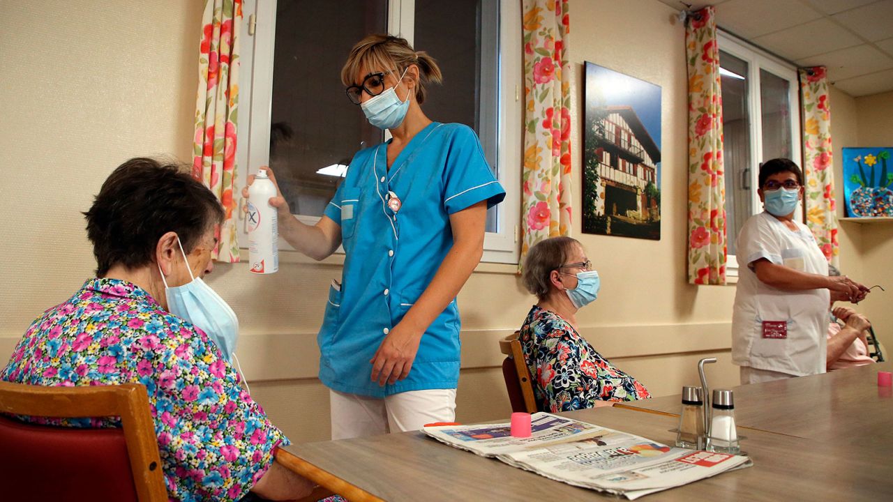 FILE - A health worker refreshes a resident of a retirement home in Isturitz, southwestern France, June 15, 2022. Crushing temperatures that blanketed Europe during the summer of 2022 may have led to more than 61,000 heat-related deaths, according to a study published Monday, July 10, 2023. (AP Photo/Bob Edme, File)