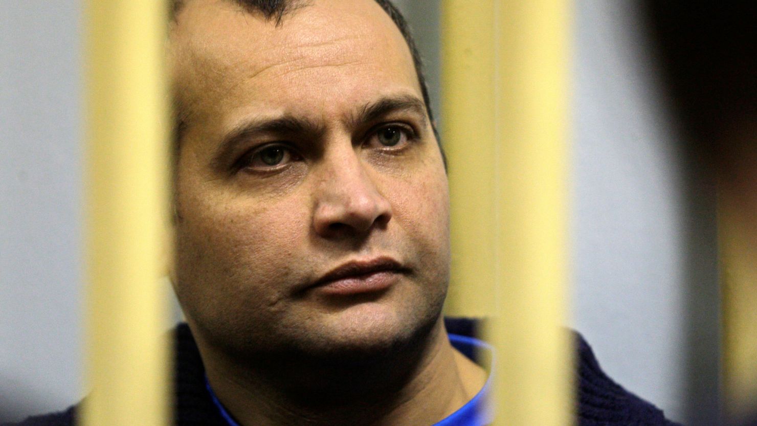 Sergei Khadzhikurbanov, a former Moscow police officer, sits behind bars at a court room in Moscow on Monday, Nov. 17, 2008. The suspects being tried on murder charges are Sergei Khadzhikurbanov _ a former Moscow police officer _ and Makhmudov's brothers, Ibragim and Dzhabrail. A Russian court ruled Monday that the trial of three men accused of involvement in the slaying of journalist Anna Politkovskaya should be open to the public. (AP Photo/ Sergey Ponomarev)
