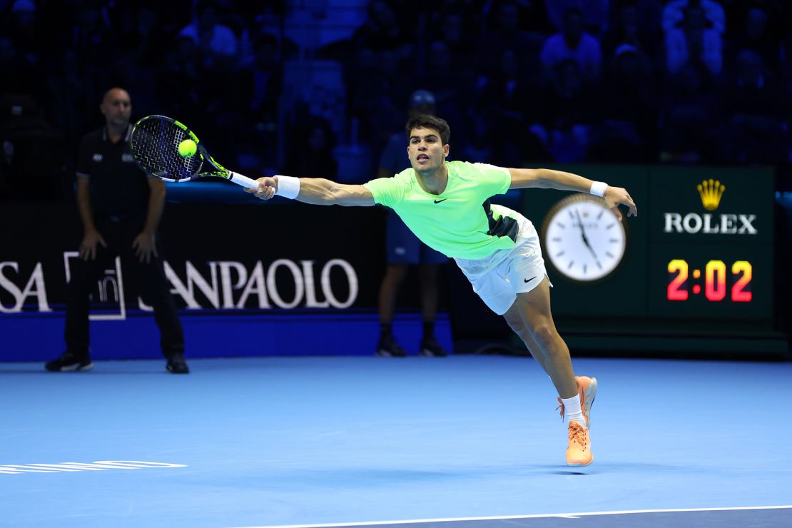 TURIN, ITALY - NOVEMBER 13: Carlos Alcaraz of Spain stretches to play a forehand against Alexander Zverev of Germany during the Round Robin match on day two of the Nitto ATP Finals at Pala Alpitour on November 13, 2023 in Turin, Italy. (Photo by Clive Brunskill/Getty Images)