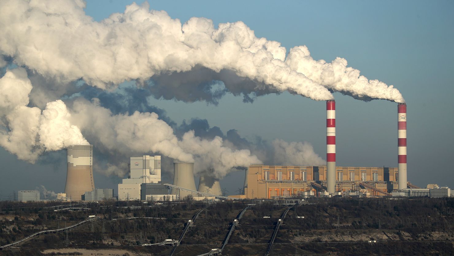 ROGOWIEC, POLAND - NOVEMBER 29: Steam and smoke rise from the Belchatow Power Station as the open-pit coal mine that feeds the station coal lies below on November 29, 2018 in Rogowiec, Poland. The Belchatow station, with an output of 5,472 megawatts, is the world's largest lignite coal-fired power station. The station emits approximately 30 million tonnes of CO2 per year. The United Nations COP 24 climate conference is due to begin on December 2 in nearby Katowice, two hours south of Belchatow.  (Photo by Sean Gallup/Getty Images)