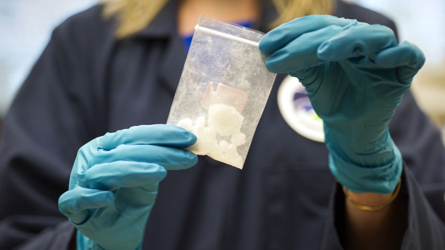 FILE - In this Aug. 9, 2016, file photo, a bag of 4-fluoro isobutyryl fentanyl which was seized in a drug raid is displayed at the Drug Enforcement Administration (DEA) Special Testing and Research Laboratory in Sterling, Va. Acting United States DEA administrator Chuck Rosenberg will visit China next week amid efforts to cut off the Chinese supply of deadly synthetic drugs, like fentanyl. China disputes U.S. claims that it's the top source of opioids. Still, Beijing has already banned fentanyl, an opioid some 50 times stronger than heroin, and 18 related compounds. (AP Photo/Cliff Owen, File)
