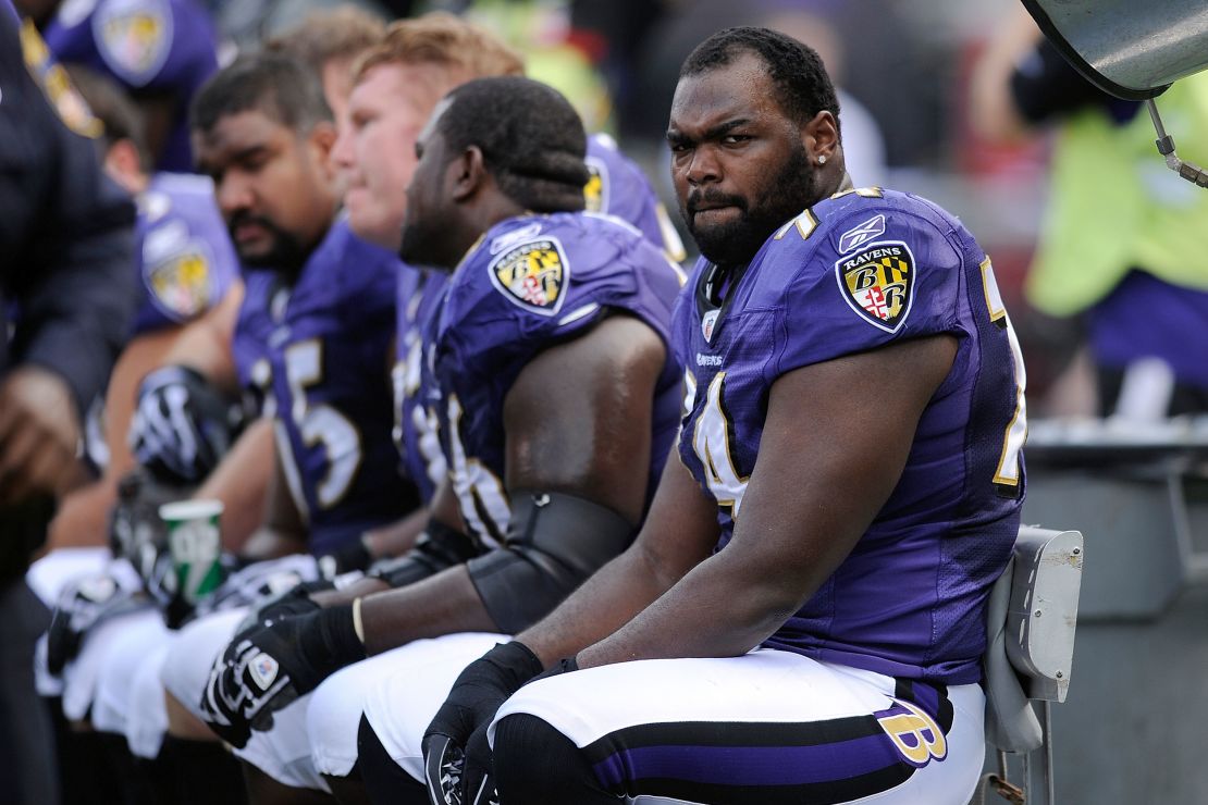FILE - Baltimore Ravens offensive tackle Michael Oher sits on the beach during the first half of an NFL football game against the Buffalo Bills in Baltimore, Sunday, Oct. 24, 2010. A Tennessee judge said Friday, Sept. 29, 2023, that she is ending a conservatorship agreement between former NFL player Oher and a Memphis couple who took him in when he was in high school. (AP Photo/Nick Wass, File)