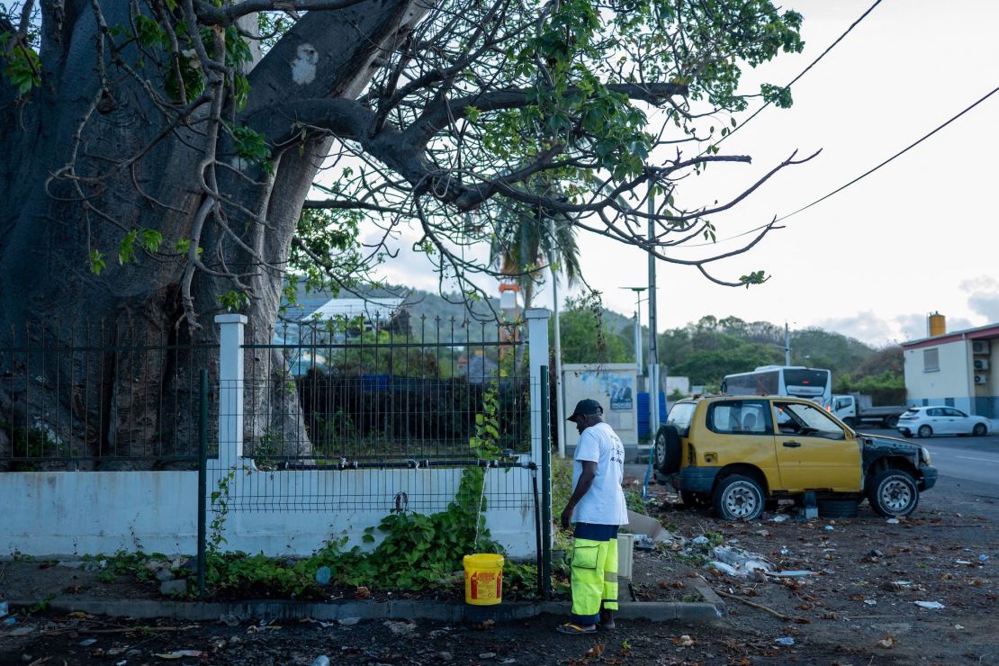 A man fills a a bucket with water at an access point in Dzaoudzi, on the French Indian Ocean island of Mayotte on November 7, 2023. In response to the worst drought on the island since 1997, running water is only available one day out of three, and only 18 hours a day, for people connected to the network. In the shanty towns of Mayotte, where many homes are not connected to the drinking water network, queues are getting longer in front of public fountains: the water crisis is particularly acute there, forcing residents to drink non-potable water. (Photo by Marion JOLY / AFP) (Photo by MARION JOLY/AFP via Getty Images)